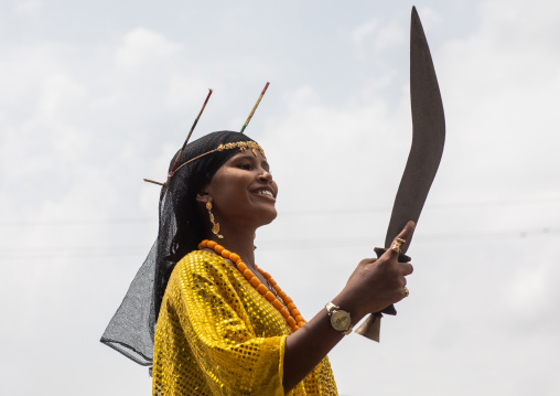 Afar tribe woman dancing with a jile knife during expo festival, Central region, Asmara, Eritrea