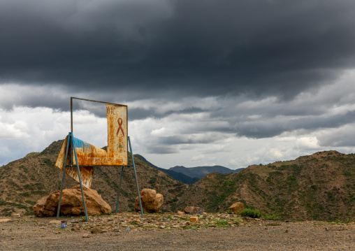 Old hiv billboard against storm clouds in the highlands, Central region, Asmara, Eritrea