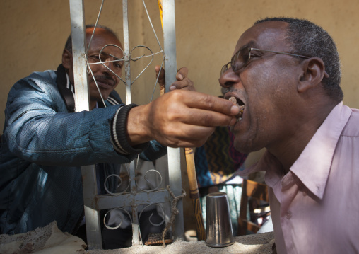 Man Feeding A Friend As A Friendship Gesture In Harar, Ethiopia
