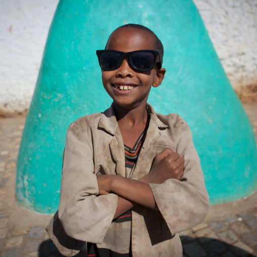 Portrait Of A Smiling Kid With Sunglasses In Harar, Ethiopia