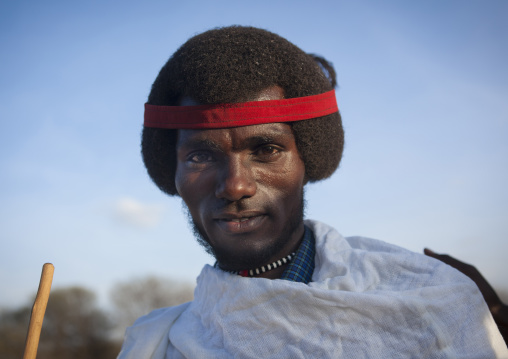 Portrait Of A Smiling Karrayyu Tribe Men With Gunfura Hairstyle And Red Hairband During Gadaaa Ceremony, Metahara, Ethiopia
