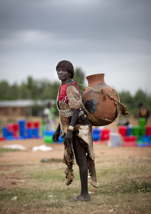Banna Woman Transporting Huge Clay Jar On Her Back At Key Afer Market Omo Valley Ethiopia