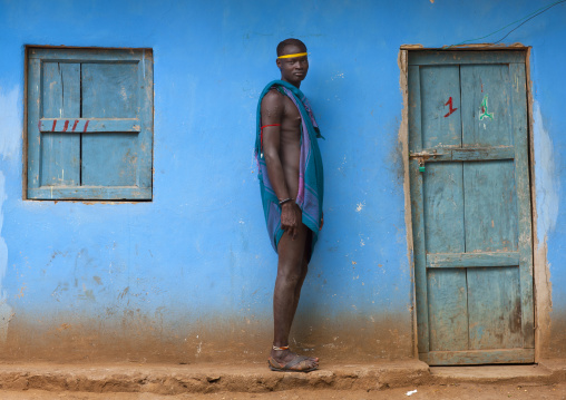 Standing Bodi Man With Scarified Skin And Headband In Front Of House Hana Mursi Village Omo Valley Ethiopia