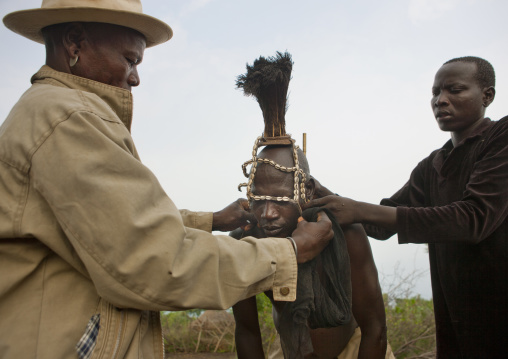 Bodi Man Putting Cauris Shell And Ostrich Plume Headgear On Before Kael New Year Ceremony Omo Valley Ethiopia