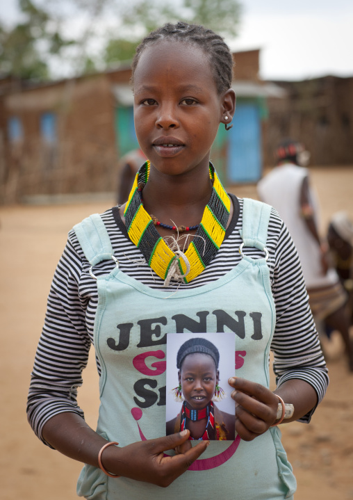 Ex Tribal Young Hamer Woman Converted To Christianity Civilization Posing With Photo Of Herself Omo Valley Ethiopia