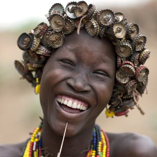 Young Smiling Dassanech Woman Wearing Bottle Caps Headdress Portrait Omo Valley  Ethiopia