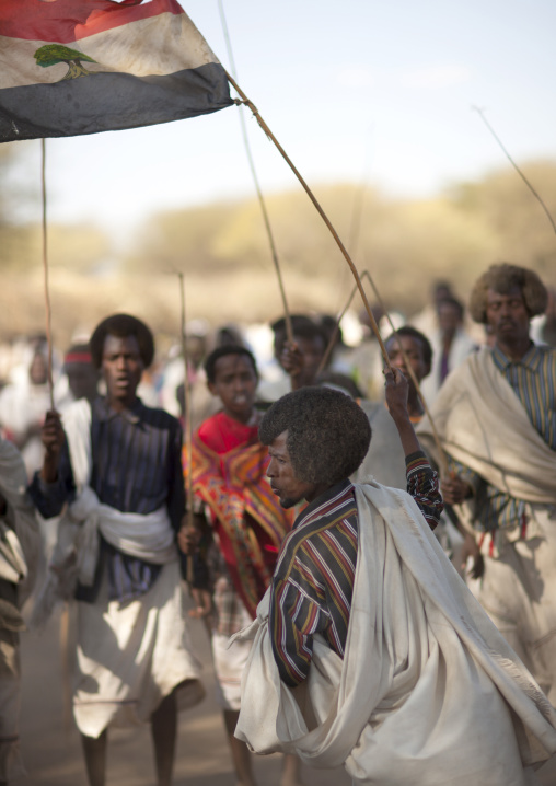 Karrayyu Tribe Man Carrying The Oromo Flag During Stick Fighting Dance, Gadaaa Ceremony, Metahara, Ethiopia