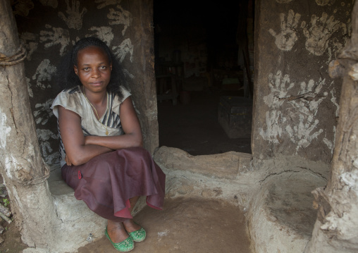 Woman And Her Son In Front Of Their Traditional House Decorated With Handprints To Bring Luck, Tepi, Ethiopia