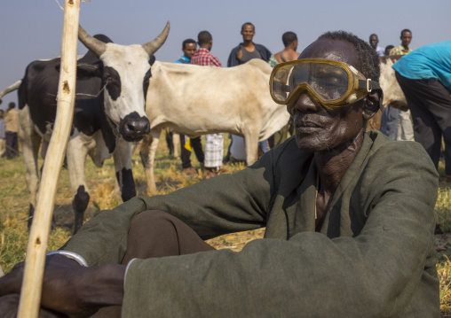 Nuer Tribe Man With A Diving Mask As Sunglasses In A  Market, Gambela, Ethiopia