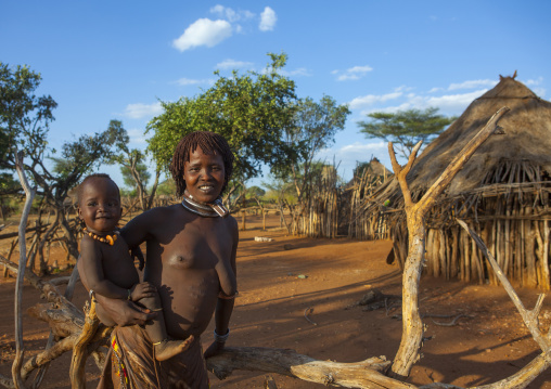Hamer Tribe Woman Carrying Her Baby In Traditional Outfit, Turmi, Omo Valley, Ethiopia