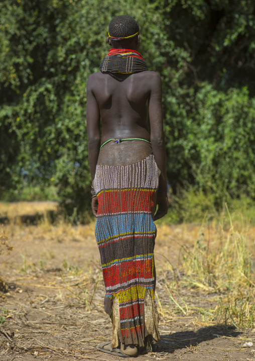 Portrait Of A Nyangatom Tribe Girl With Traditional Beaded Skirt, Omo Valley, Kangate, Ethiopia