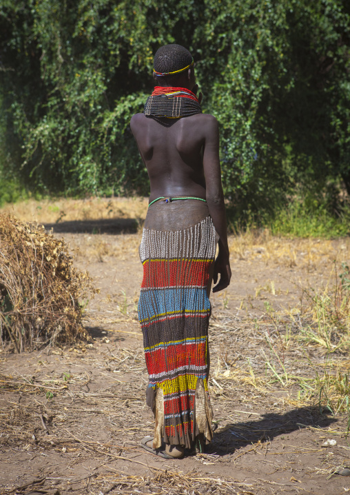 Portrait Of A Nyangatom Tribe Girl With Traditional Beaded Skirt, Omo Valley, Kangate, Ethiopia