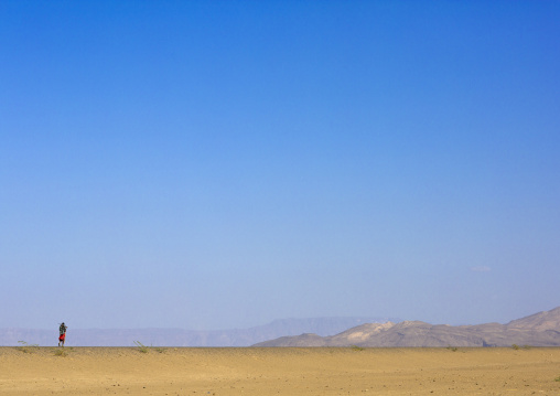 Afar Tribe Man Walking Alone In The Desert, Assayta, Ethiopia