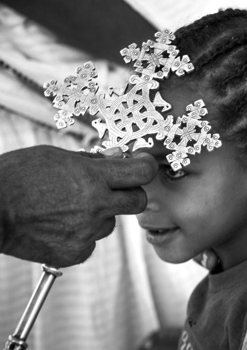 Ethiopian Orthodox Priest Blessing The Pilgrims With A Cross During The Timkat Epiphany Festival, Lalibela, Ethiopia