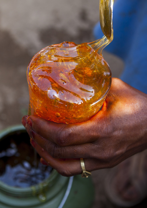 Woman Holding A Pot Of Honey In A Market, Metahara, Ethiopia