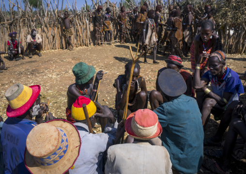 Men Negociating During A Mourning Ceremony To Know How Many Cows Will Be Killed In Hamer Tribe, Turmi, Omo Valley, Ethiopia