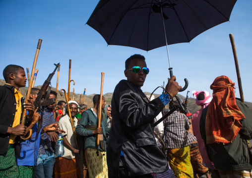Oromo groom with an umbrella during his wedding celebration, Oromo, Sambate, Ethiopia