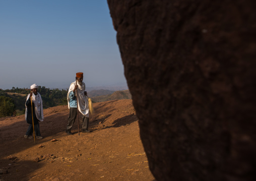 Ethiopian priests walking along a hill, Amhara region, Lalibela, Ethiopia