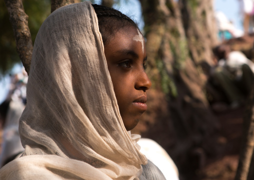 Pilgrim girl with a cross sign on the forehead during kidane mehret orthodox celebration, Amhara region, Lalibela, Ethiopia