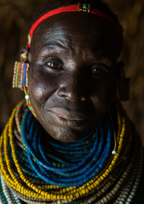 Nyangatom tribe woman with piles of beads, Omo valley, Kangate, Ethiopia