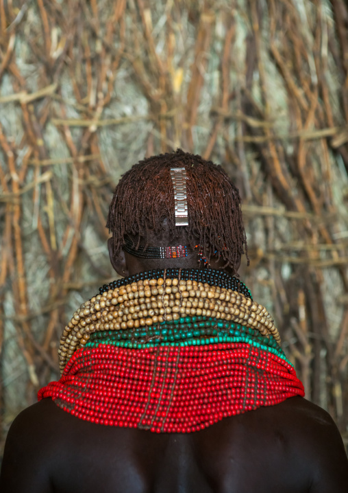 Nyangatom tribe woman with piles of beads, Omo valley, Kangate, Ethiopia