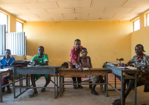 Hamer tribe teenage boys in classroom with their teacher, Omo valley, Turmi, Ethiopia