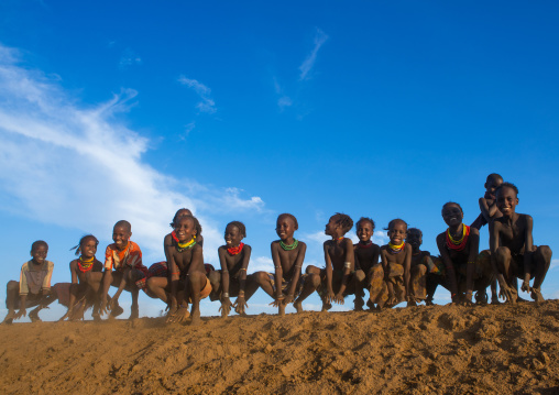 Dassanech tribe children dancing and jumping, Omo valley, Omorate, Ethiopia