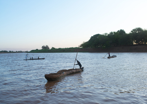Trunk boats crossing the omo river, Omo valley, Omorate, Ethiopia