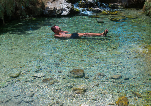 Tourist swimming in a hot spring, Afar region, Afdera, Ethiopia