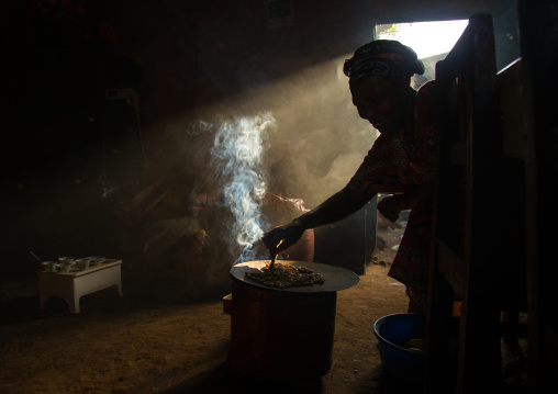 Ray of light in a house during a coffee ceremony, Omo valley, Jinka, Ethiopia