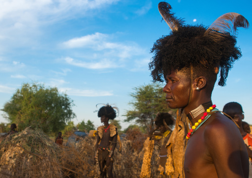 Dassanech men with leopard skins and ostrich feathers headwears during dimi ceremony to celebrate circumcision of teenagers, Omo valley, Omorate, Ethiopia