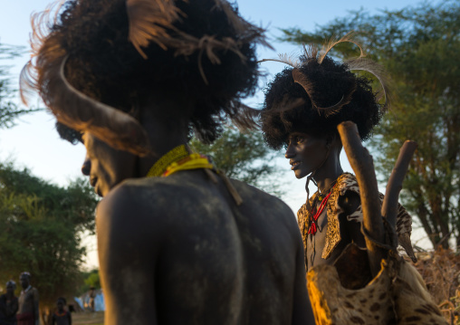 Dassanech men with leopard skins and ostrich feathers headwears during dimi ceremony to celebrate circumcision of teenagers, Omo valley, Omorate, Ethiopia