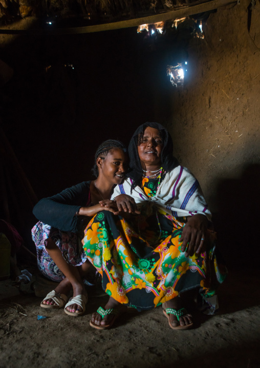 A karrayyu tribe girl called aliya who was the first girl educated in her tribe pausing with her mother, Oromia, Metehara, Ethiopia