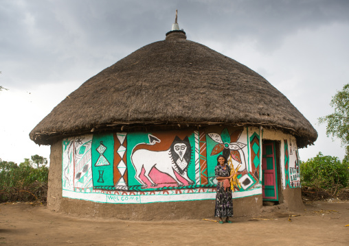 Ethiopia, Kembata, Alaba Kuito, ethiopian woman standing in front of her traditional painted house
