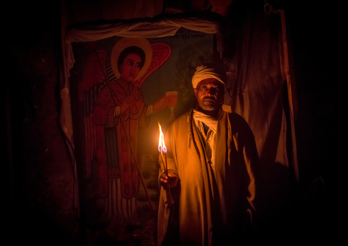 Ethiopian priest holding a candle during kidane mehret orthodox celebration, Amhara region, Lalibela, Ethiopia