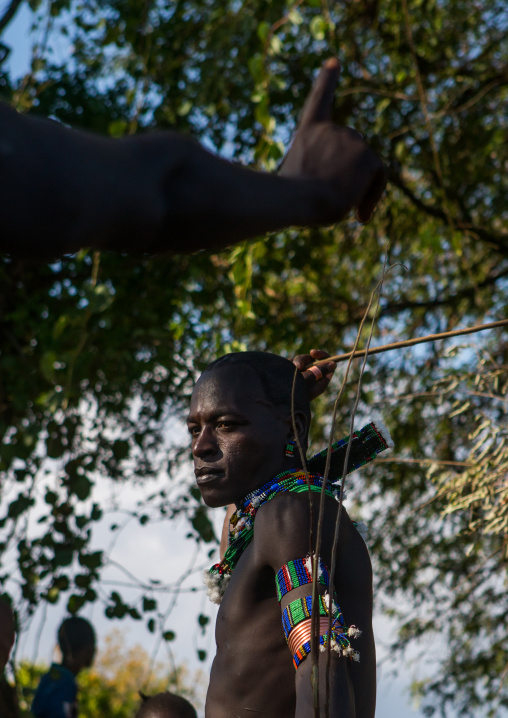 Hamer tribe maze whipping a woman during a bull jumping ceremony, Omo valley, Turmi, Ethiopia