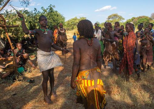 Hamer tribe maze whipping a woman during a bull jumping ceremony, Omo valley, Turmi, Ethiopia