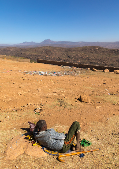 Ethiopian man chewing khat in front of a valley, Oromia, Babile, Ethiopia