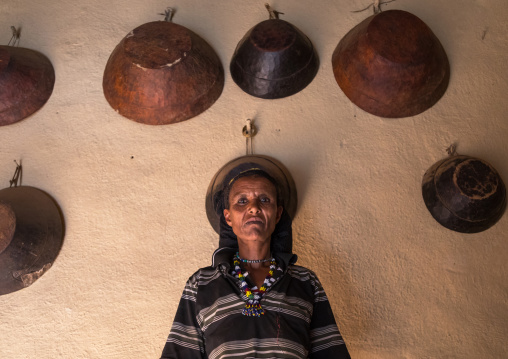 Woman inside her house decorated with leather baskets in a traditional Argoba stone houses village, Harari Region, Koremi, Ethiopia
