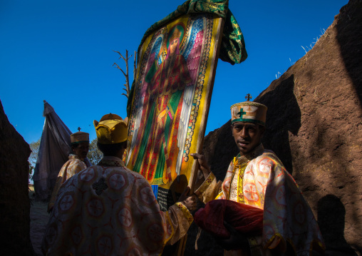 Monks taking out of Mariam rock church the flags for Timkat celebration, Amhara region, Lalibela, Ethiopia