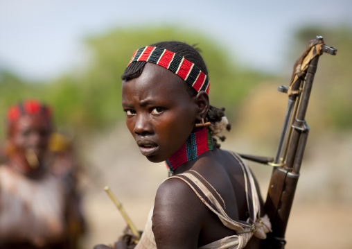 One Young Hamer Woman Holding Ak47 Looks Backwards At Bull Jumping Ceremony Omo Valley Ethiopia