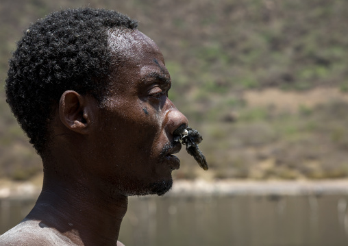 Borana tribe man with protection in his nose ready to dive in the volcano crater to collect salt, Oromia, El Sod, Ethiopia