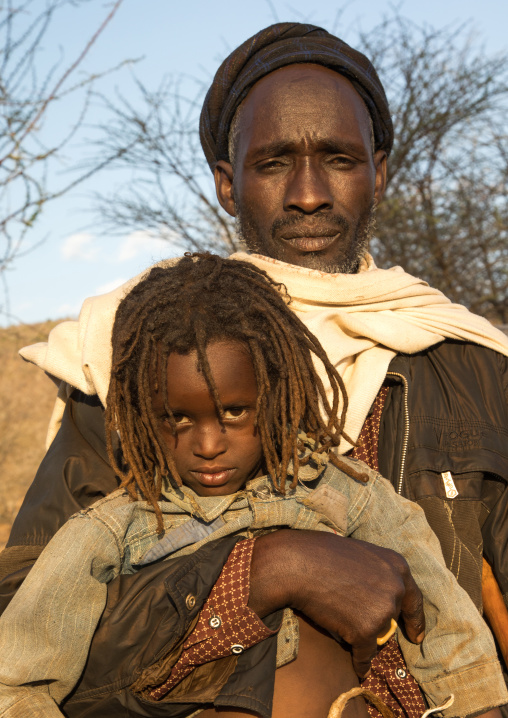 Dabale age grade boy with his father during the Gada system ceremony in Borana tribe, Oromia, Yabelo, Ethiopia