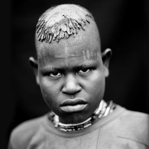 Menit woman with a cross shaped scar on the forehead, Tum market, Omo valley, Ethiopia