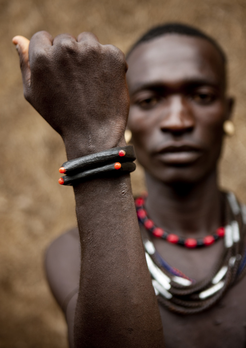 Menit man showing his bracelet at tum market, Omo valley, Ethiopia