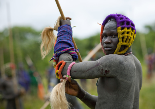 Suri tribe warriors fighting during a donga stick ritual, Omo valley, Tulgit, Ethiopia