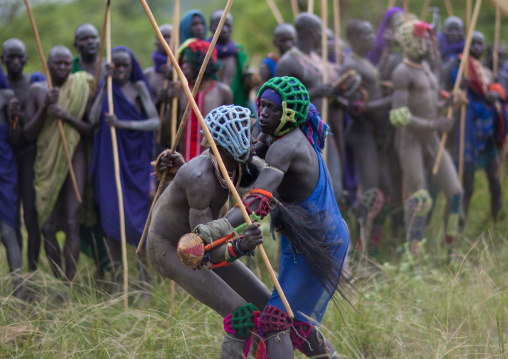 Suri tribe warriors fighting during a donga stick ritual, Omo valley, Tulgit, Ethiopia