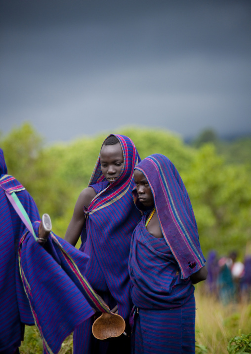 Teenagers watching a donga stick fighting session, Tulgit, Omo valley, Ethiopia