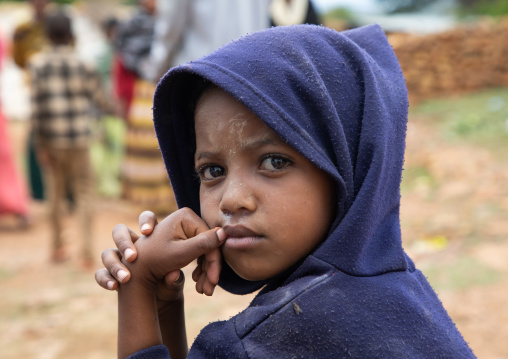 Oromo pilgrim boy in Sheikh Hussein shrine with jarawa powder on the face, Oromia, Sheik Hussein, Ethiopia