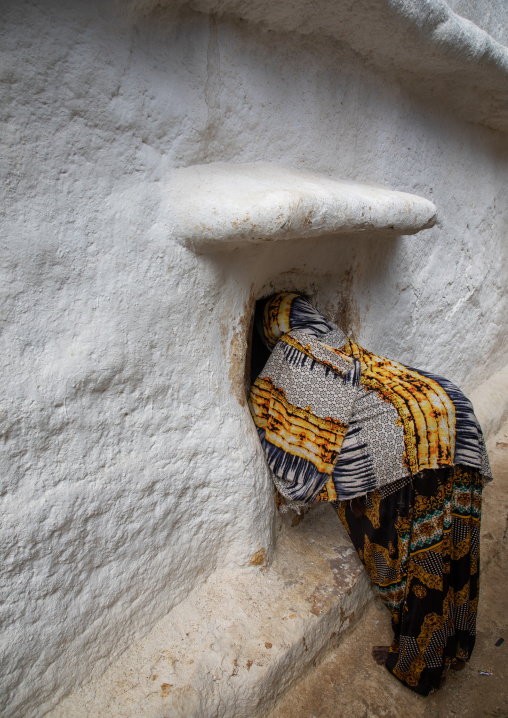 Oromo pilgrim woman looking inside the shrine which hosts the tomb of sufi Sheikh Hussein , Oromia, Sheik Hussein, Ethiopia